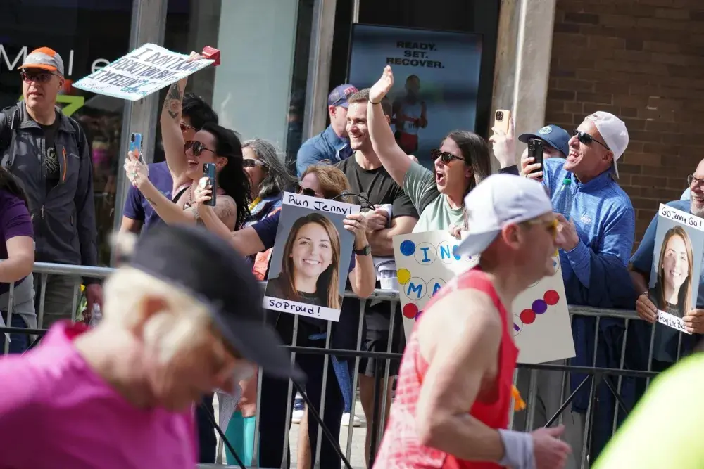 Crowds of supporters cheering on runners at Back Bay, Boston, during the 2024 marathon