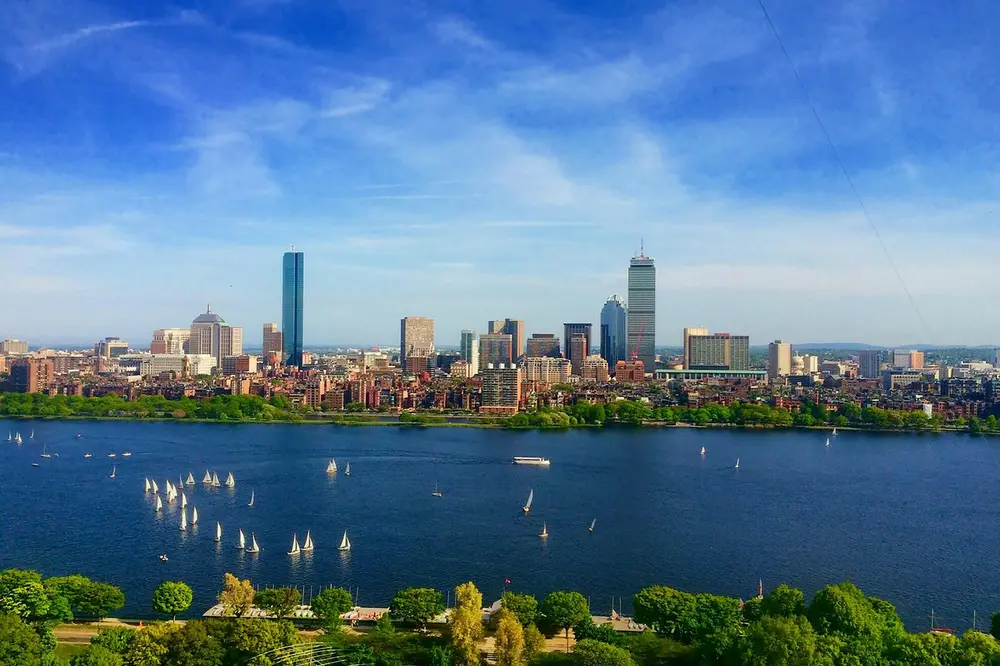Aerial view of the Boston skyline and sailboats on the Charles River on a clear summer day;