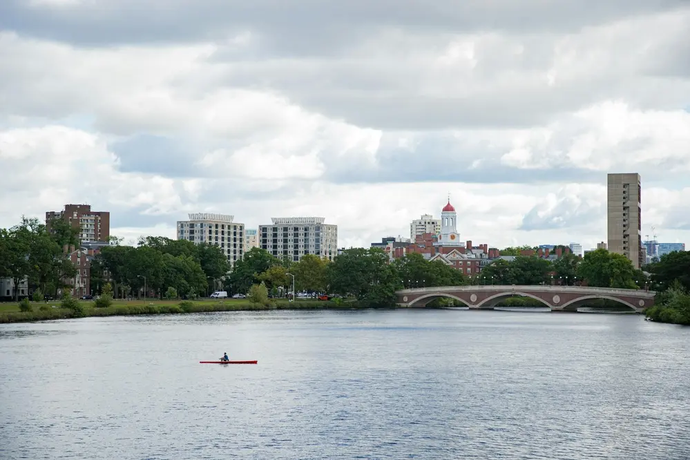 Kayaker on the Charles River with the Harvard campus and John W. Weeks Footbridge in the background